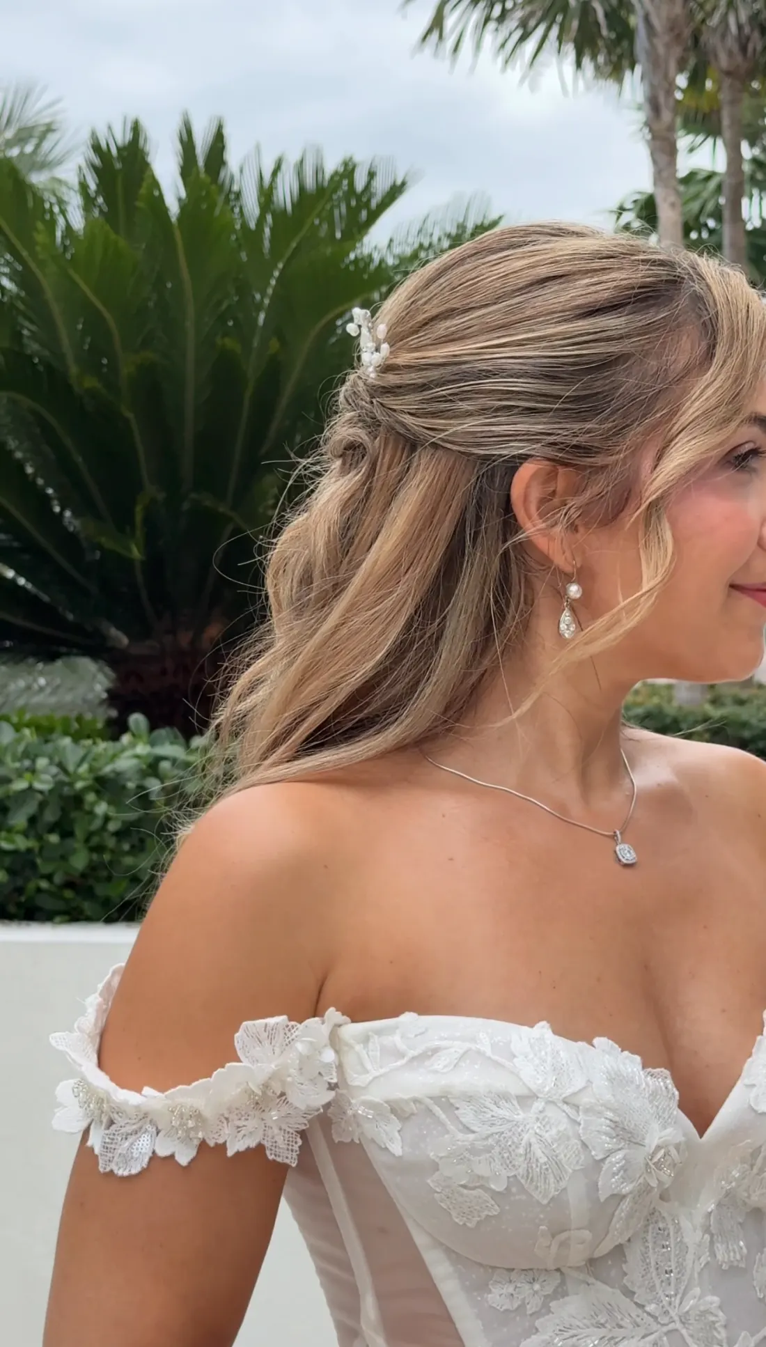 Bride in profile with pearl hair pin and drop earrings